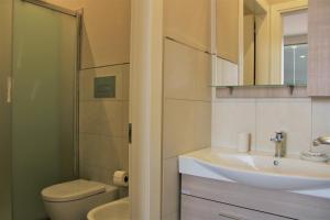 a bathroom with a sink and a toilet and a shower at Zibibbo Beach Apartments - Trapani in Trapani