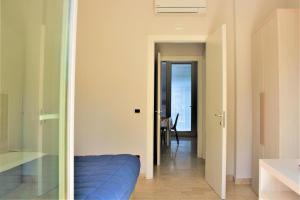 a hallway with a blue bed in a room at Zibibbo Beach Apartments - Trapani in Trapani