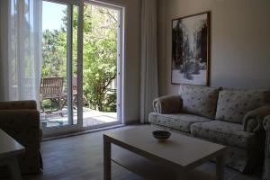 a living room with a couch and a table at Karadağ Apart Hotel in Buyukada