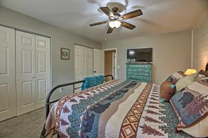 a bedroom with a bed and a ceiling fan at Near Woodland Lake Park Cabin with Serene Deck! in Pinetop-Lakeside