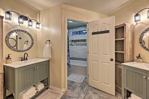 a bathroom with two sinks and a mirror at Near Woodland Lake Park Cabin with Serene Deck! in Pinetop-Lakeside +35 photos