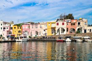 a group of buildings next to a river with boats at Le Signore by Tizzano House in Procida
