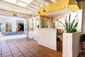 a restaurant entrance with a yellow and white awning at Apartamentos Pepe Mesa in Nerja