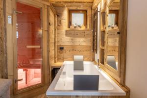 a tiny house with a white table in a room at Ciandolada Wellness in Vodo Cadore