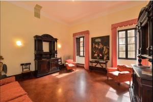 a large living room with a couch and chairs at Palazzo Danesi in Montepulciano