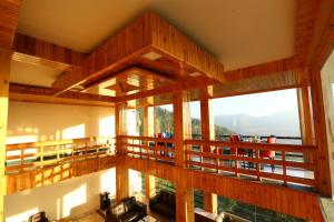 a large room with a balcony with a view at The Byke Nature Vilas Pure Veg in Shimla