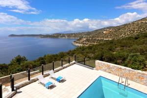 a villa with a swimming pool and a view of the water at WONDERFUL ECO FRIENDLY VILLA AUGUSTINE in Ambelón