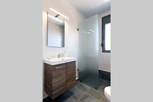 a bathroom with a sink and a mirror and a toilet at WONDERFUL ECO FRIENDLY VILLA AUGUSTINE in Ambelón +16 photos