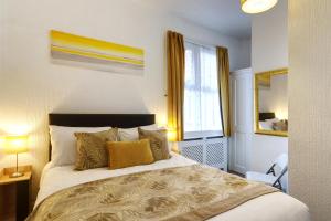 a bedroom with a large bed and a window at Palm Court in Skegness