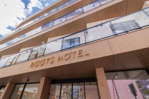 a building with the words roosts hotel on it at Roots Hotel in Faro