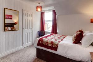 a hotel room with a bed and a window at Palm Court in Skegness