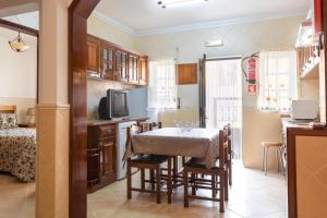 a kitchen and dining room with a table and chairs at Moradia Borda D'Água in Nazaré