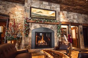 a living room with a fireplace with christmas decorations at Elk Country Inn in Jackson