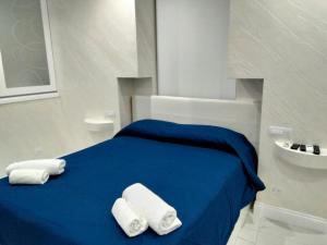 a bedroom with a blue bed with towels on it at DuoArianna in Naples
