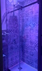 a bathroom with a shower with purple tiles at B&B Angolo83 Palermo centro in Palermo +49 photos