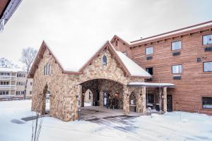 a large brick building with an archway in the snow at Elk Country Inn in Jackson