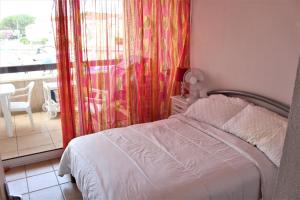 a bedroom with a bed and a view of a balcony at Amirauté I 21 2pieces 4 personnes in Saint-Cyprien