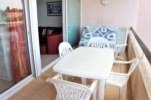 a white table and chairs on a balcony at Amirauté I 21 2pieces 4 personnes in Saint-Cyprien +4 photos