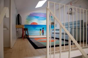 a bedroom with a mural of a beach at Lo Scorcio sul mare in Marina San Vito
