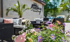 a bunch of flowers in front of a patio at Munkácsy Hotel in Békéscsaba