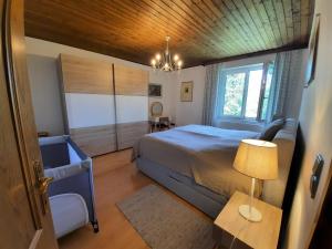 a bedroom with a bed and a chair and a lamp at Villa Agnes in Semmering