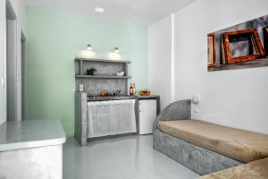a living room with a couch and a kitchen at Coralli Seaside Resort in Livadakia