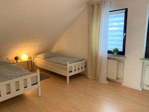a bedroom with two beds and a window at Ferienwohnung am Teutoburger Wald 2 in Oerlinghausen