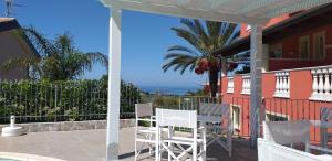 a patio with a table and chairs on a house at Borgo di Santa Barbara in Santa Domenica