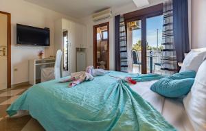 a bedroom with a bed with slippers on it at Villa San Rocco Bed & Breakfast in Medulin