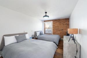 a bedroom with two beds and a window at Colorado Ave East 101 - Ski Loft House in Telluride