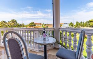 a table and chairs on a balcony with a view at Villa San Rocco Bed & Breakfast in Medulin
