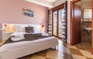 a bedroom with a bed and a bathroom with a sink at Villa San Rocco Bed & Breakfast in Medulin