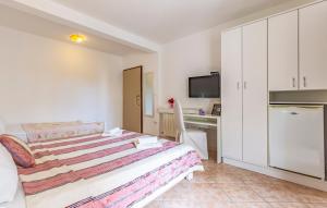 a bedroom with a bed and a desk and a tv at Villa San Rocco Bed & Breakfast in Medulin