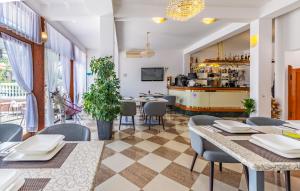 a restaurant with tables and chairs and a bar at Villa San Rocco Bed & Breakfast in Medulin
