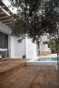 a wooden deck with a pool in a house at The Hidden Gem in Skiathos