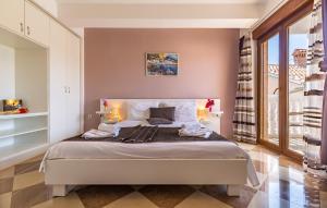 a bedroom with a large bed with two lamps at Villa San Rocco Bed & Breakfast in Medulin