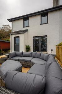 a large couch sitting in front of a house at Modern 2 Bedroom House in Portree