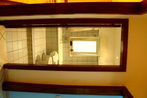 a mirror in a bathroom with a window at Da Lorenzo Apartment in Gaggi
