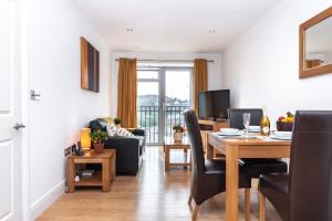 a living room with a dining table and a living room at The Old Library - Newbury Town Centre - Within easy reach of Train Station and Racecourse - Excellent road links via the A34 and M4 in Newbury