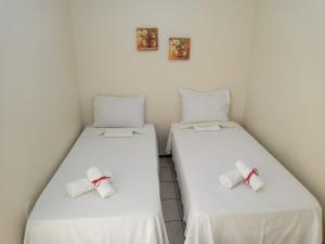 Säng eller sängar i ett rum på Pousada Aconchego
