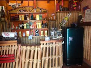 a bar with a refrigerator and a shelf with alcohol at Alttum El Carmelo in Venecia