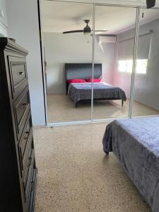 a bedroom with a large mirror and a bed at La Casona Beach House in Fajardo
