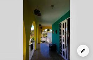 a hallway of a house with yellow and green walls at La Casona Beach House in Fajardo