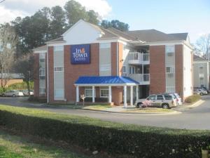 a hotel with a sign that reads inn town halls at InTown Suites Extended Stay Raleigh Garner NC in Garner