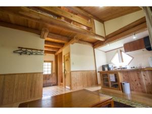 a large room with wooden walls and a wooden table at Log house for 12 people - Vacation STAY 35069v in Minamioguni