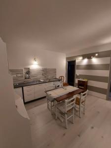 a kitchen with a table and chairs in a room at Casa De Batté in Riomaggiore +18 photos