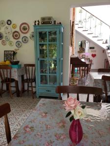a living room with a blue cabinet and a table at Pousada Vila Rosada in Florianópolis