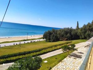 a view of a beach and the ocean from a balcony at Akrothalassia in Ligia