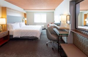 a hotel room with a bed and a desk at Holiday Inn Marquette, an IHG Hotel in Marquette