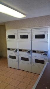 four white ovens lined up against a wall at InTown Suites Extended Stay El Paso TX in El Paso